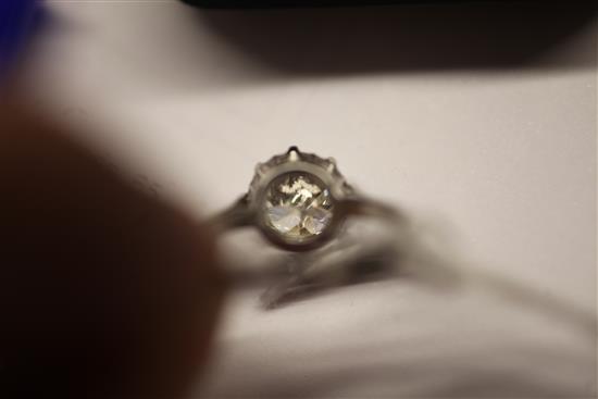 A modern platinum and solitaire diamond ring, size Q.